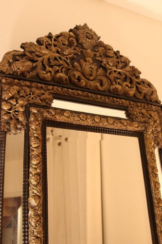 XIXe siècle - Miroir à fronton en laiton repoussé et ébène, début XIXe