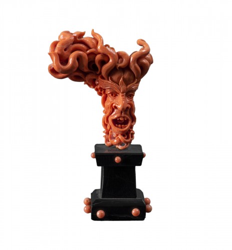 Carved red coral depicting grotesque figure