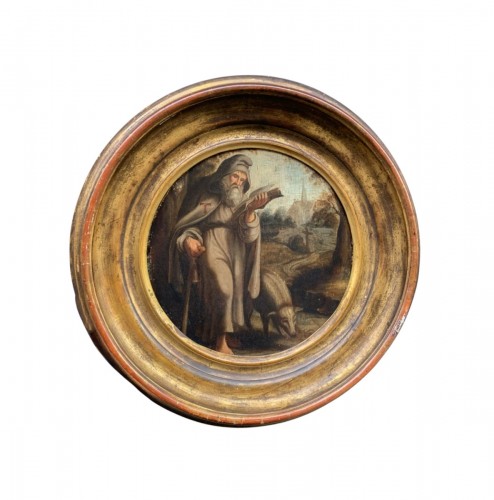 St. Anthony Abbot with pig in a Flemish landscape with church. XVIIth cent