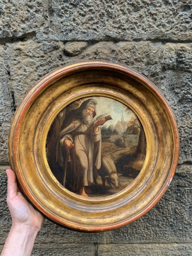 Louis XIII - St. Anthony Abbot with pig in a Flemish landscape with church. XVIIth cent