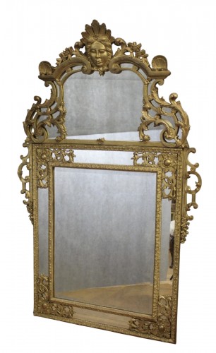 Miroir Régence à Parecloses en bois sculpté et doré XVIIIe