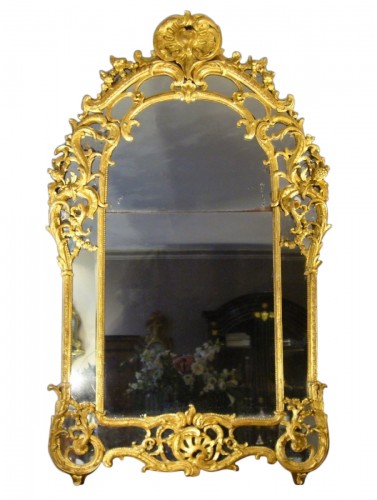 A very decorative Louis XV pierced, carved, and giltwood mirror