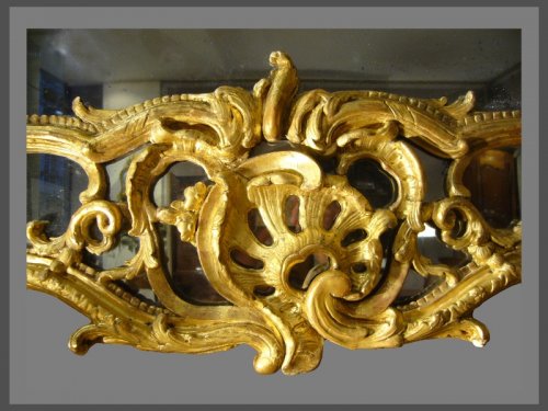 Mirrors, Trumeau  - A very decorative Louis XV pierced, carved, and giltwood mirror