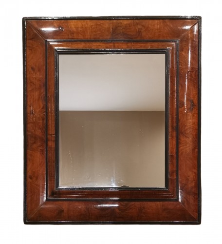 A Louis XIV walnut cushion-framed mirror  late 17th century, circa 1680.