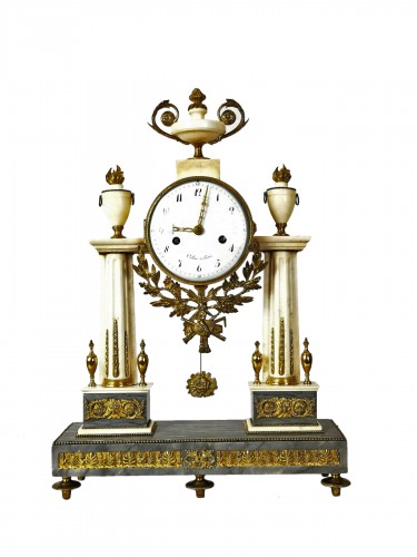 A Louis XVI portico marble and gilt-bronze mantel clock.