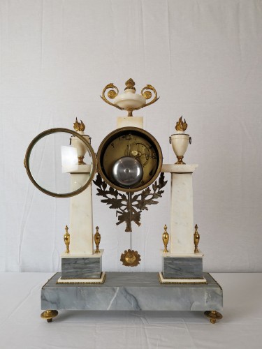 Horology  - A Louis XVI portico marble and gilt-bronze mantel clock.