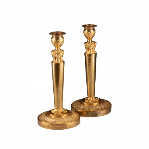 Pair of candlestick in finely chased bronze gilded with mercury.