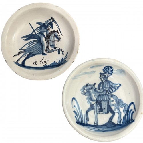 Two earthenware dishes decorated with horsemen Northern France 18th century