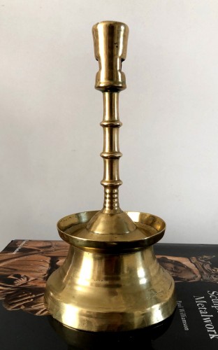 Lighting  - A Gothic brass Candlestick.Late 15th century.