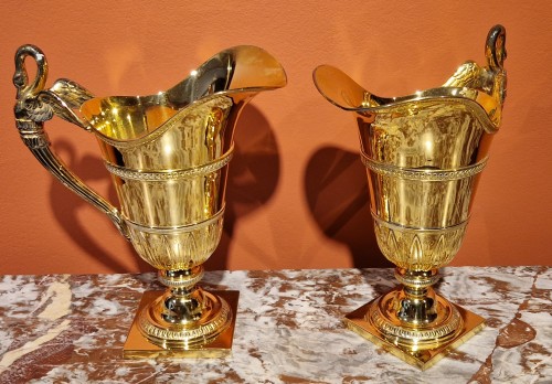 A pair of French silver-gilt ewers - 