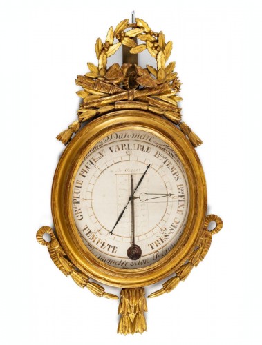 A Louis XVI carved gilt wood barometer - thermometer