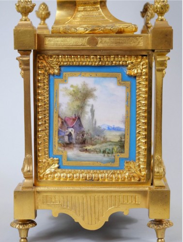 Horology  - A gilt bronze and painted porcelain clock