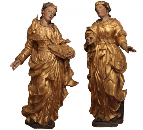 Sainte Barbe et Sainte Catherine, paire de statues début XVIIIe en bois sculpté, doré et laqué.