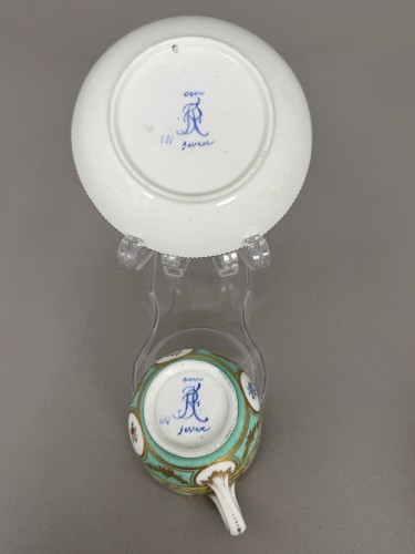 Antiquités - Sèvres soft-paste porcelain cup and saucer with floral reserves