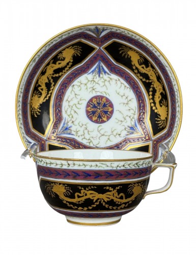 A Sèvres (hard paste) porcelain cup and saucer, black and mauve ground