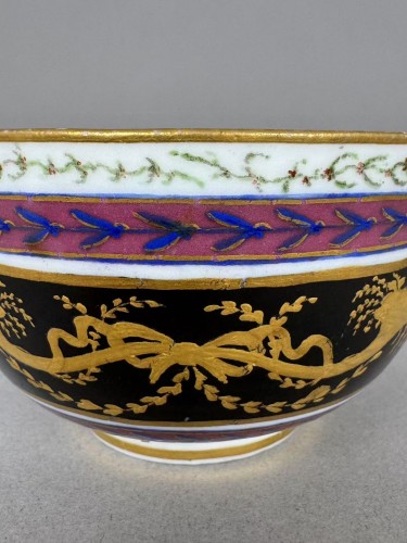 A Sèvres (hard paste) porcelain cup and saucer, black and mauve ground - 