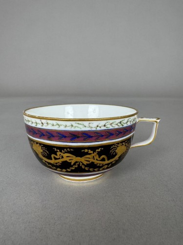  - A Sèvres (hard paste) porcelain cup and saucer, black and mauve ground