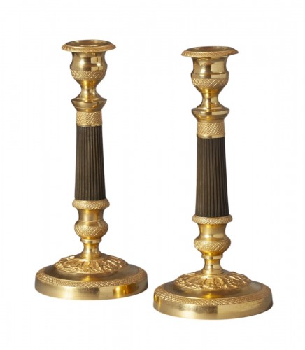 A pair of ormolu and bronze Charles X candlesticks