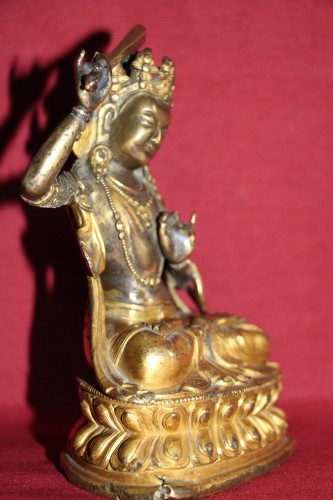 Antiquités - Buddha of wisdom with sword Manjushri out of gilded bronze, Tibet, at the end of XVIIe.