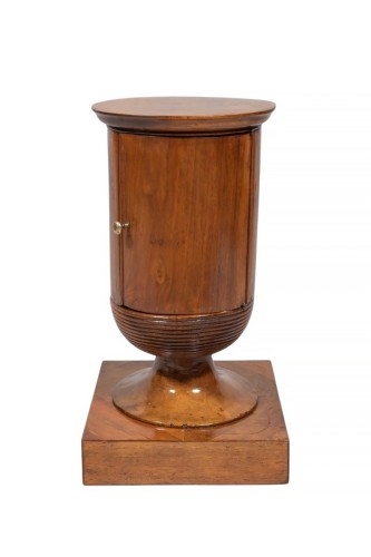 A vase-shaped cabinet circa 1830