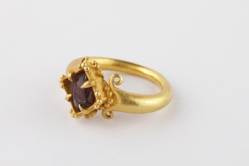 A Fine Temple Ring Set with a Rough Garnet - 