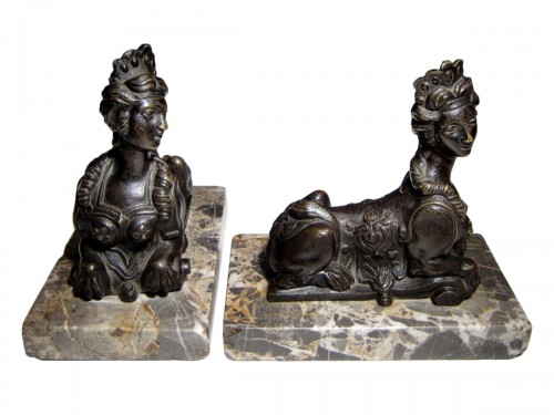 A pair of French Regence bronze sphinxes