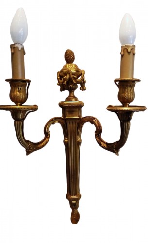 A pair of louis XVI ormolu two branch wall lights