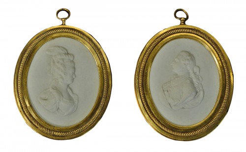 A pair of hard paste biscuit Louis XVI and Marie Antoinette portraits