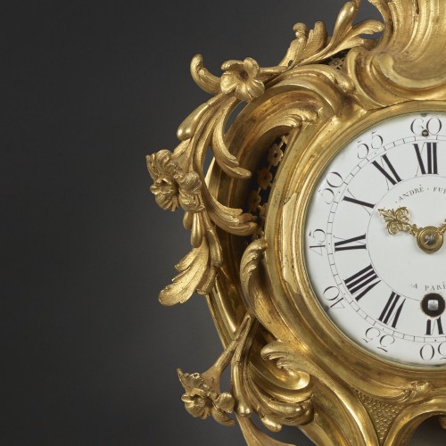 Horology  - An alcove cartel clock in chased and gilt bronze