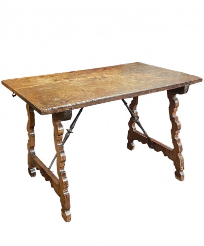 A spanish carved walnut folding center table