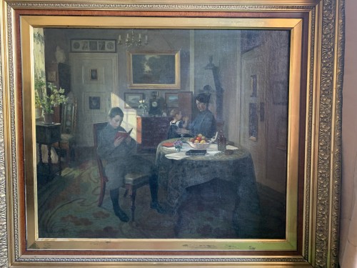 Valdemar Kornrup (1865-1924)  - Young Reader In A Family Interior - 