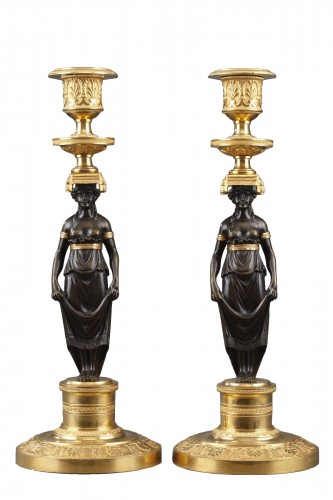 An early pair of ormolu and patinated bronze candelsticks