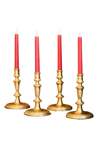 suite of four gilt bronze candlesticks