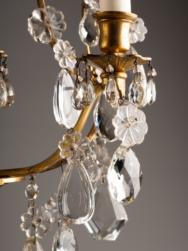 Lighting  - A pair of gilt-bronze and cut-crystal three-light girandoles
