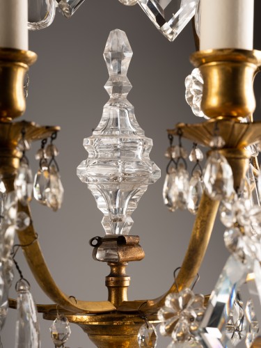 Antiquités - A pair of gilt-bronze and cut-crystal three-light girandoles