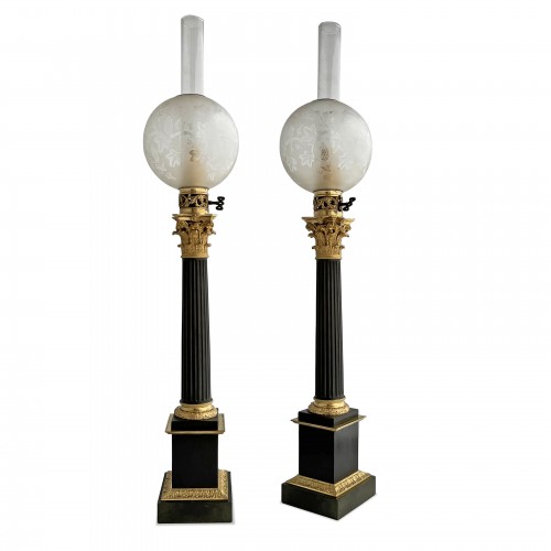 A pair of Restauration ormolu and patinated bronze Carcel lamps