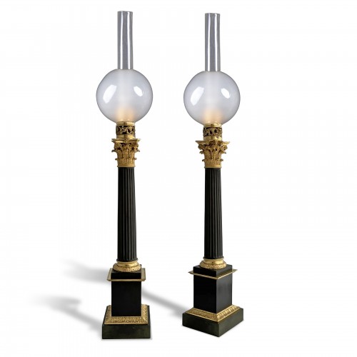 A pair of patinated and gilded bronze columnar Carcel lamps