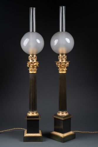 Lighting  - A pair of patinated and gilded bronze columnar Carcel lamps