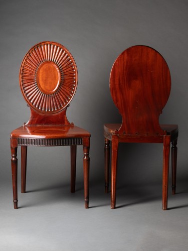  - A pair of George III Mahogany Hall Chairs in the manner of Mayhew &amp; Ince