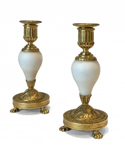 A pair of Louis XVI ormolu mounted Carrara marble candlesticks