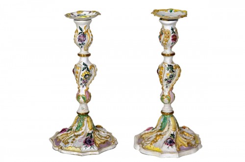 A pair of English George III Battersea enamel candlesticks