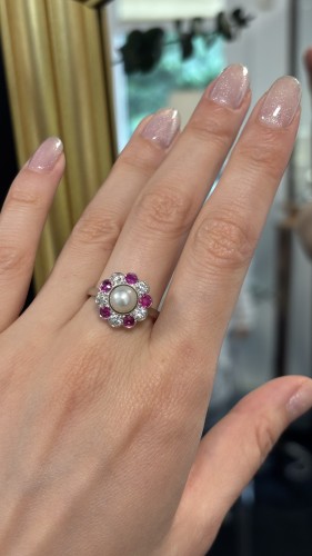 A platinum, natural pearl, ruby, and diamond ring, circa 1920. - 
