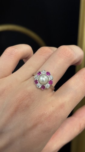 20th century - A platinum, natural pearl, ruby, and diamond ring, circa 1920.