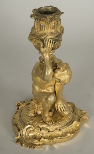Gilt bronze candlestick depicting a man sat on a rock - 
