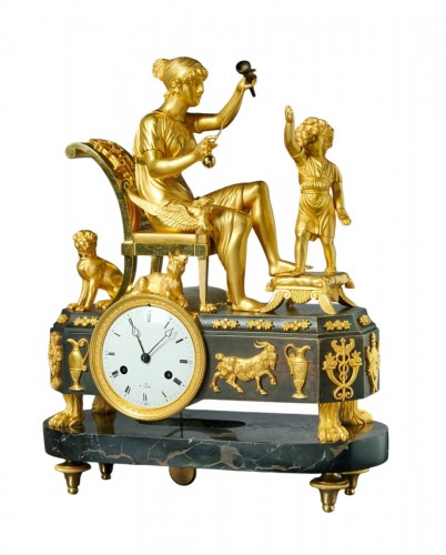 A French Empire Gilt and Patinated Bronze and Marble Mantel Clock