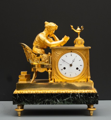 Horology  - An Empire gilt bronze mantel clock "La Liseuse", the dial signed Le Roy