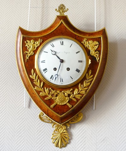 Horology  - Empire cartel clock in escutcheon