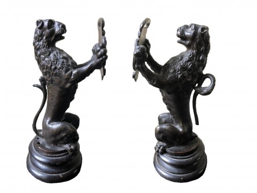 Pair of bronze lions holding a coat of arms