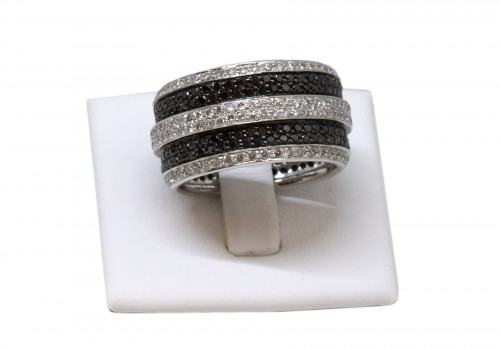 White gold ring set with small white and black diamonds