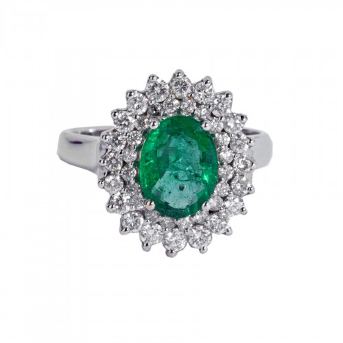 white gold ring set with an emerald and small diamonds